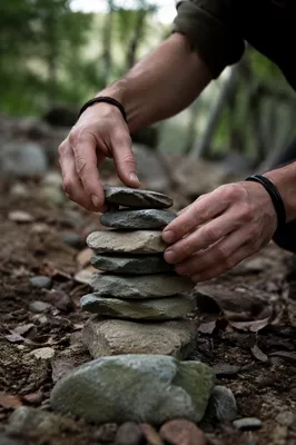Hands Building a Forest Stone Altar