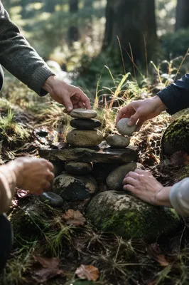 Hands Building Stone Altar in Forest