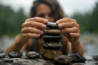 Hands Building a Woodland Stone Altar