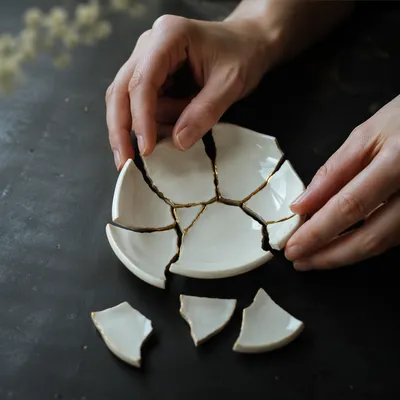 Gentle Hands Restoring Broken Kintsugi Bowl