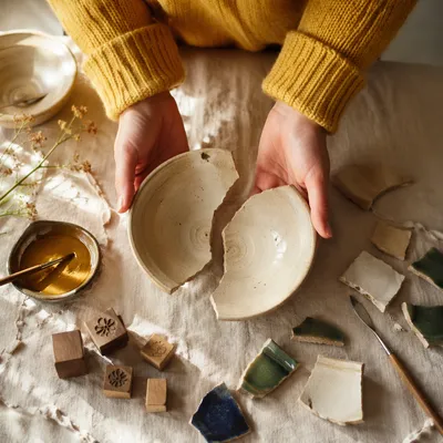Hands Holding Broken Pottery for Kintsugi