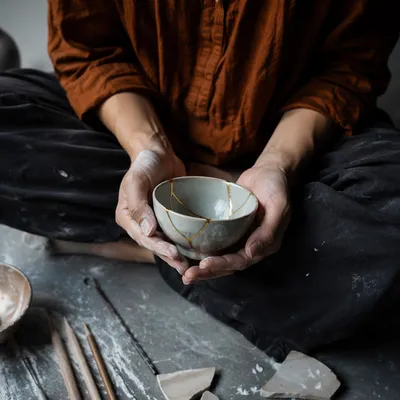 Kintsugi Hands Holding Restored Broken Bowl