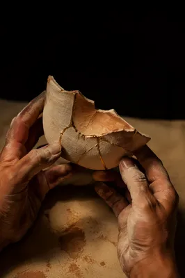 Kintsugi Pottery in Clay-Stained Hands