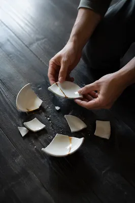 Hands Holding Broken Pottery for Kintsugi