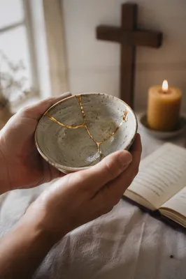 Hands Holding Kintsugi Bowl in Prayer Corner