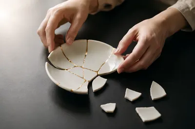 Gentle Hands Restoring Broken Pottery With Gold