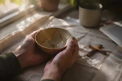 Hands Holding Kintsugi Bowl of Healing Faith