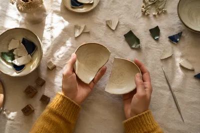 Hands Holding Broken Pottery for Kintsugi
