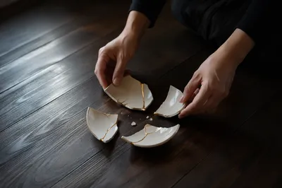 Hands Holding Broken Pottery for Kintsugi