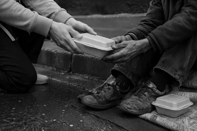 Compassionate Hands Serving a Hot Meal