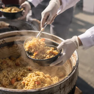 Volunteers Serving Hot Meals Outdoors