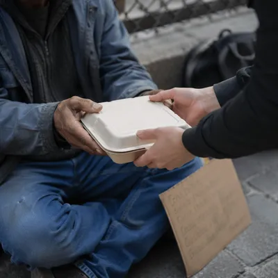 Compassionate Food Handoff on City Sidewalk