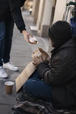 Compassionate Food Handoff on City Sidewalk