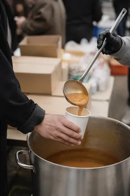 Volunteers Serving Hot Soup to Homeless