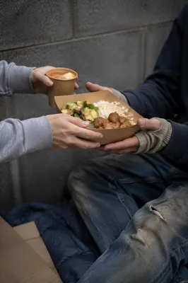 Volunteer Hands Sharing Warm Meal