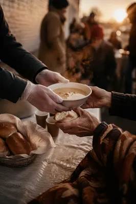 Compassionate Hands Serving Soup at Sunrise
