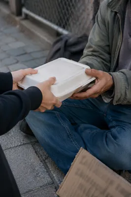 Compassionate Food Handoff on City Sidewalk