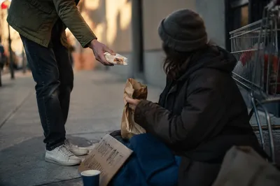 Compassionate Food Handoff on City Sidewalk