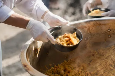 Volunteers Serving Warm Meals Outdoors