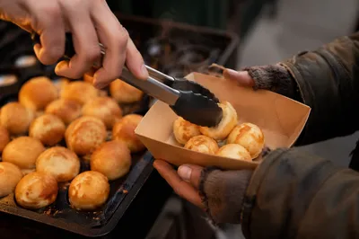 Volunteer Hands Serving Warm Pastries