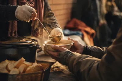 Compassionate Hands Serving Warm Meal Outdoors