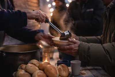 Compassionate Hands Serving Warm Meal Outdoors