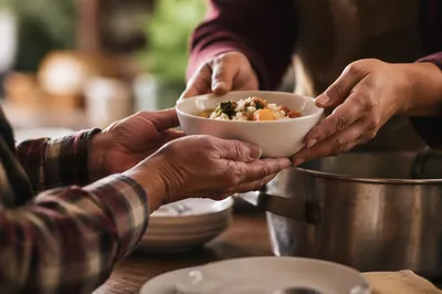 Caring Hands Serving Warm Meal