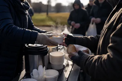 Volunteers Serving Warm Meals Outdoors