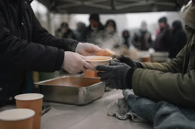 Compassionate Hands Serving Soup to Homeless