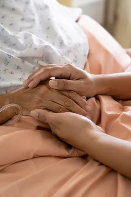 Hospital Bedside Prayer Holding Elderly Patient Hand
