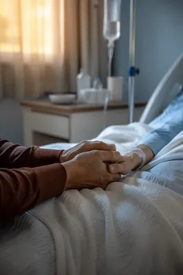 Bedside Prayer Holding a Patient Hand