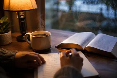 Hands Writing Journal Beside Morning Coffee