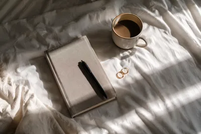 Morning Coffee and Notebook on Bedding
