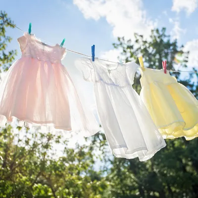 Sunlit Children’s Dresses on Backyard Clothesline