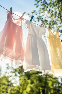 Sunlit Children's Dresses on Backyard Clothesline
