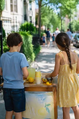 Children Running Lemonade Stand on Summer Sidewalk
