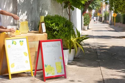 Children's Lemonade Stand on Sunny Sidewalk