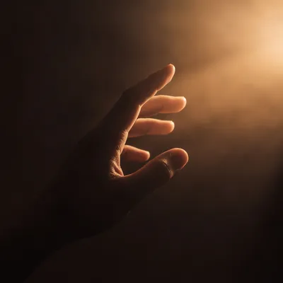 Hand Reaching Toward Warm Hopeful Light