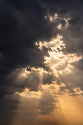 Hopeful Sunlight Through Dark Storm Clouds
