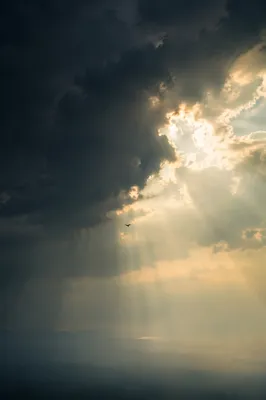 Hopeful Sunlight Through Dark Storm Clouds