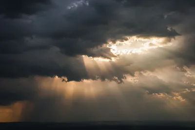 Golden Sunbeams Breaking Through Storm Clouds