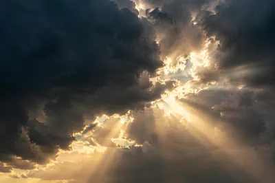 Sunlight Breaking Through Dark Storm Clouds