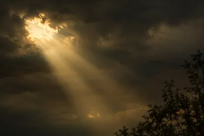 Sunlight Breaking Through Dark Storm Clouds