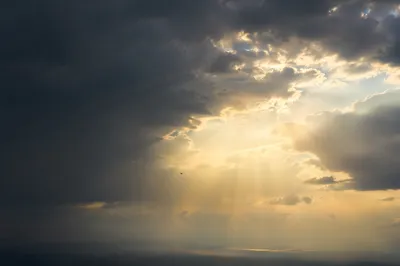 Hopeful Sunlight Through Storm Clouds