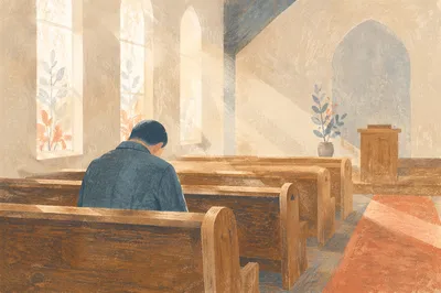 Man Praying Alone in Quiet Chapel Pew