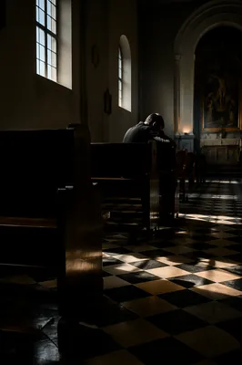 Man Praying Alone in Historic Church
