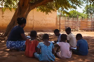 Missionary Teaching Children Under African Tree