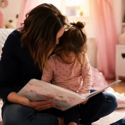 Mother and Child Reading in Cozy Room