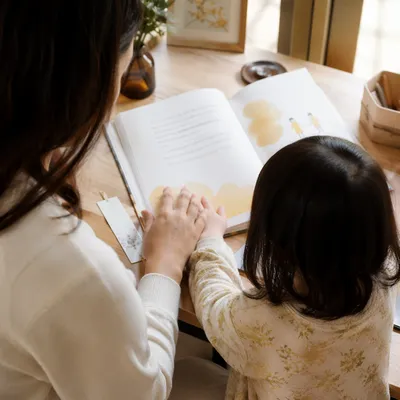 Mother and Child Reading at Warm Desk