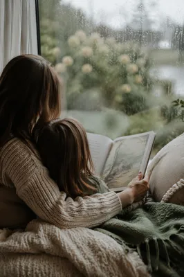 Mother and Child Reading by Rainy Window